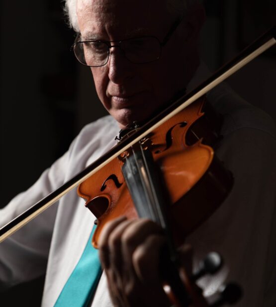 Celebrant Ronald Cruickshank plays the Viola